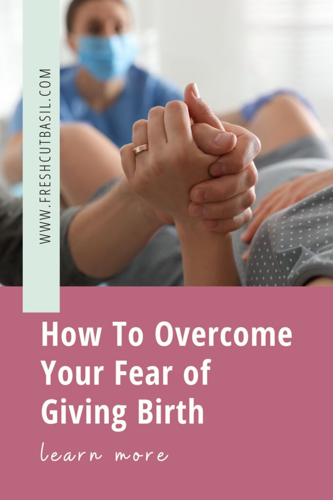 woman giving birth holding partners hand with provider in background